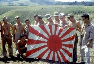 American soldiers holding captured Japanese flag on Guadalcanal Island during WWII. Photo by Frank Scherschel